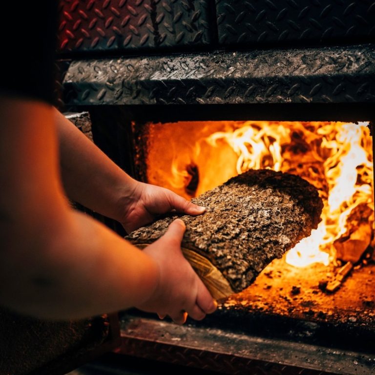 Placing wood into the fire for our fresh bbq